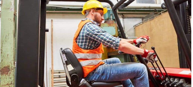 Worker operating forklift